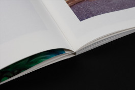 close-up photography of a photobook lying on a black background