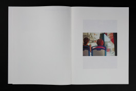 spreads of a photobook lying on a black background