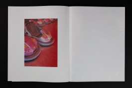 spreads of a photobook lying on a black background