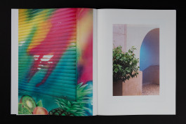 spreads of a photobook lying on a black background