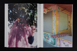 spreads of a photobook lying on a black background