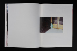 spreads of a photobook lying on a black background