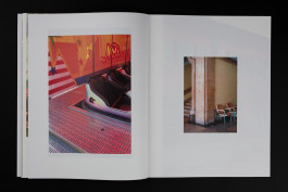 spreads of a photobook lying on a black background