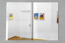 Spreads of an art publication on a grey background