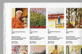 Spreads of an art publication on a grey background