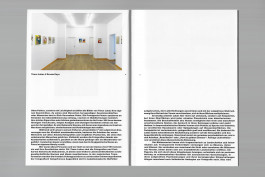 Spreads of an art publication on a grey background