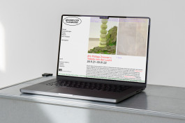 Photography of a MacBook standing on a metal shelf. 
