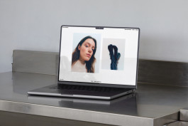 photography of a macbook standing on a steel table showing the website of photographer felix gundlach 